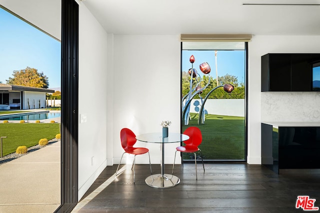 dining space featuring dark wood-type flooring