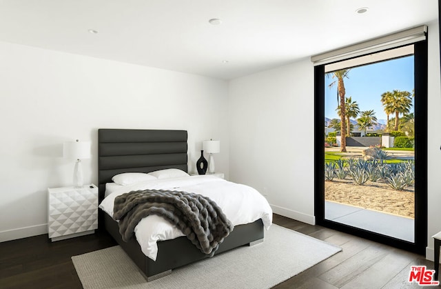 bedroom featuring wood-type flooring and access to exterior