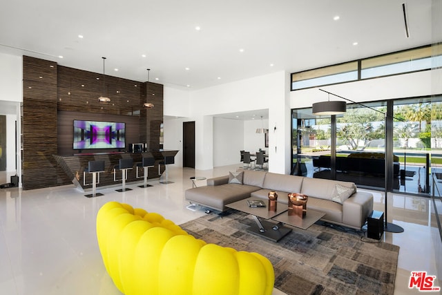 living room featuring tile patterned floors and expansive windows