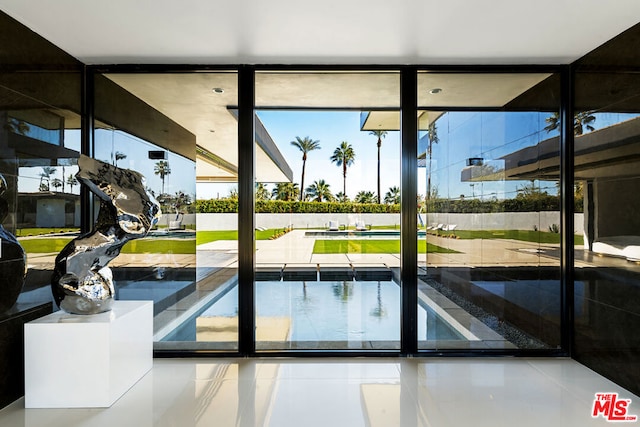 doorway featuring expansive windows and tile patterned floors