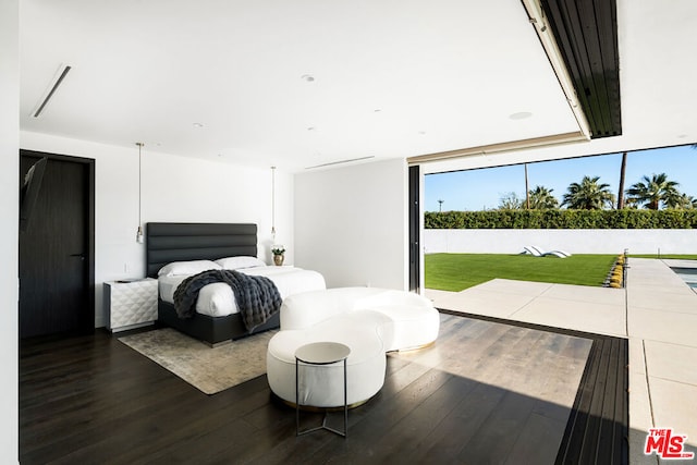 bedroom with dark hardwood / wood-style flooring