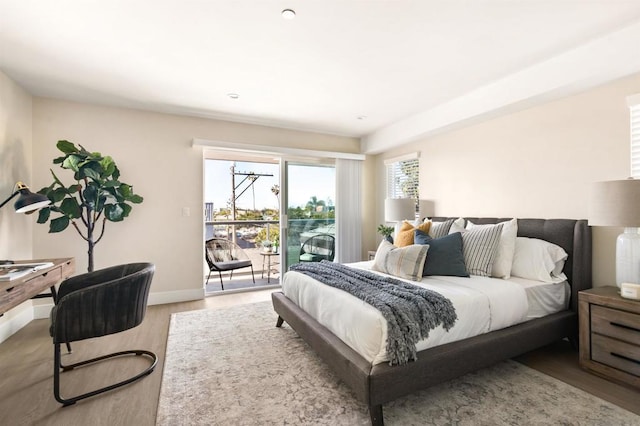 bedroom featuring light hardwood / wood-style floors and access to outside