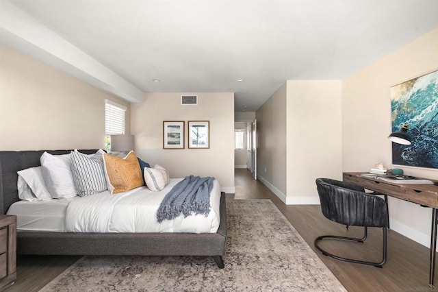 bedroom with dark hardwood / wood-style floors