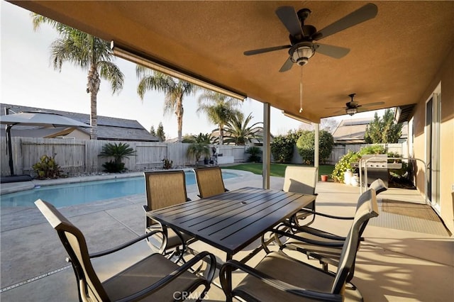 view of patio featuring ceiling fan and a fenced in pool