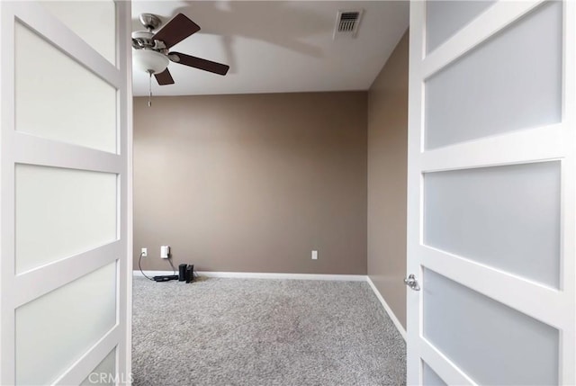 carpeted empty room featuring ceiling fan