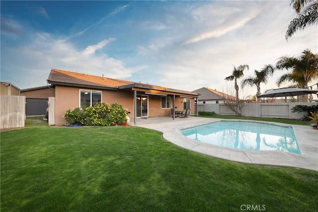 view of pool with a patio area and a lawn