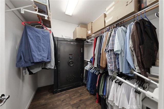 spacious closet with dark hardwood / wood-style flooring