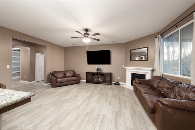 living room with ceiling fan and light wood-type flooring