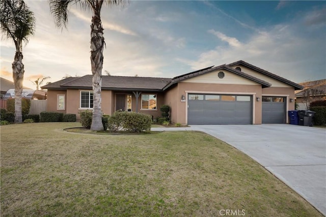 ranch-style home with a garage and a lawn