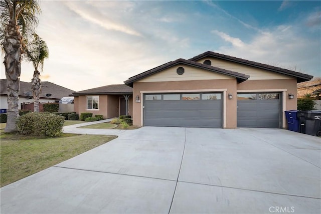 ranch-style house featuring a garage and a front yard