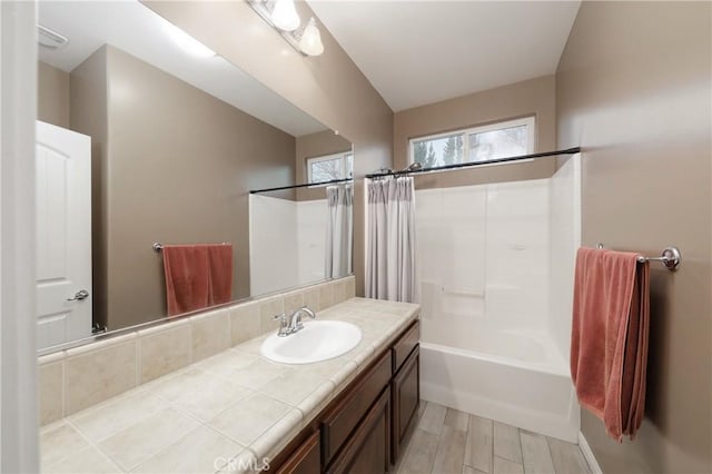 bathroom with vanity and shower / bath combo