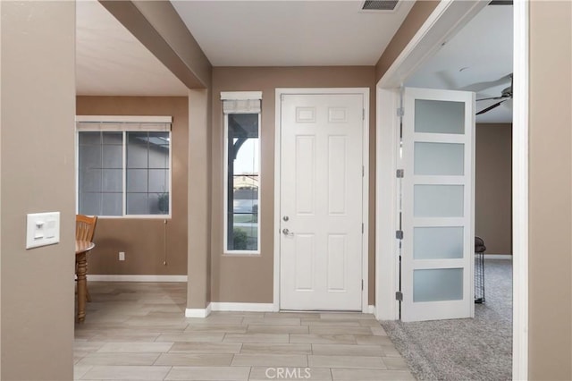 foyer entrance featuring light hardwood / wood-style floors and ceiling fan