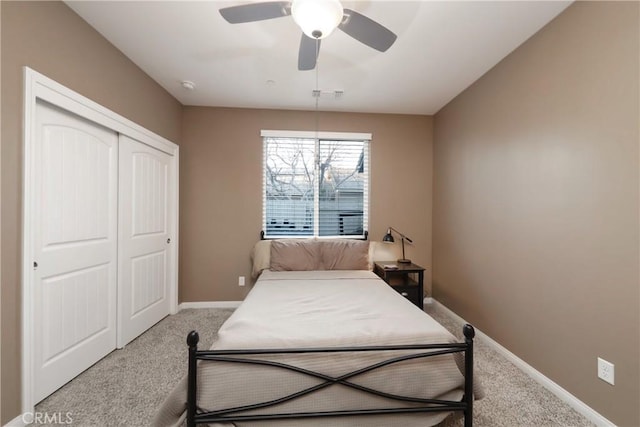 carpeted bedroom with a closet and ceiling fan