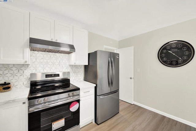 kitchen featuring white cabinetry, stainless steel appliances, decorative backsplash, and light wood-type flooring