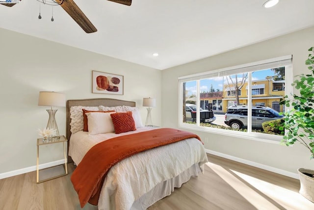 bedroom featuring hardwood / wood-style flooring and ceiling fan