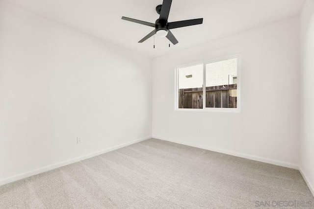 empty room featuring carpet floors and ceiling fan