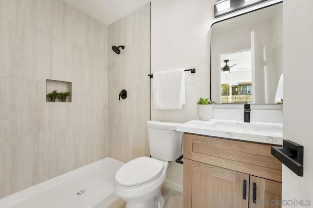 bathroom with vanity, a shower, and toilet