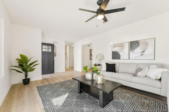 living room with hardwood / wood-style flooring and ceiling fan