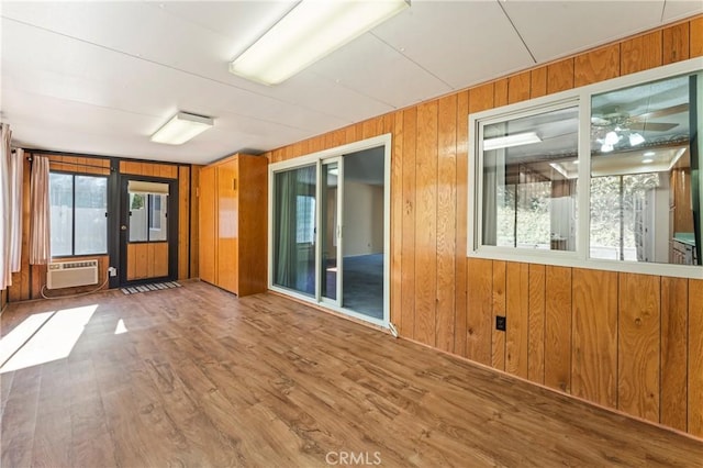 spare room with wooden walls and wood-type flooring