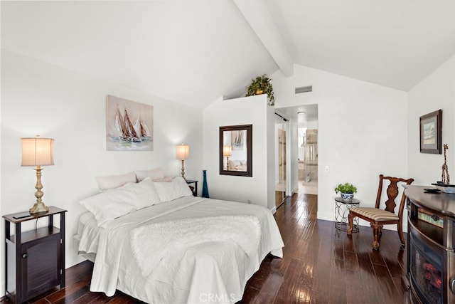 bedroom with lofted ceiling with beams, dark wood-type flooring, and connected bathroom