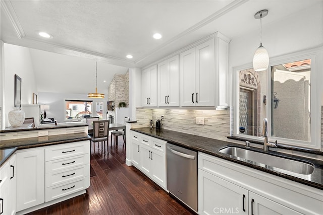 kitchen featuring pendant lighting, sink, stainless steel dishwasher, and white cabinets