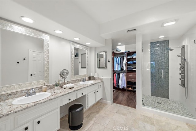 bathroom featuring vanity, tile patterned floors, and walk in shower