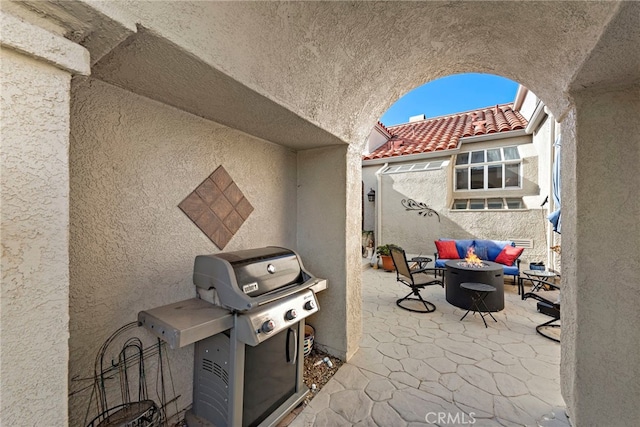 view of patio featuring area for grilling and an outdoor fire pit