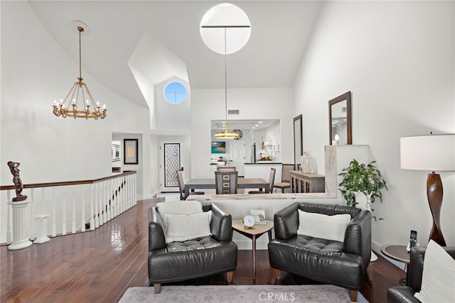 living room featuring an inviting chandelier, hardwood / wood-style floors, and high vaulted ceiling