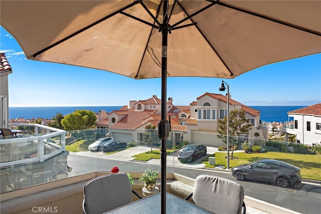 balcony featuring a water view