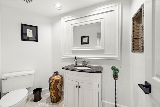 bathroom featuring tile patterned floors, toilet, and vanity