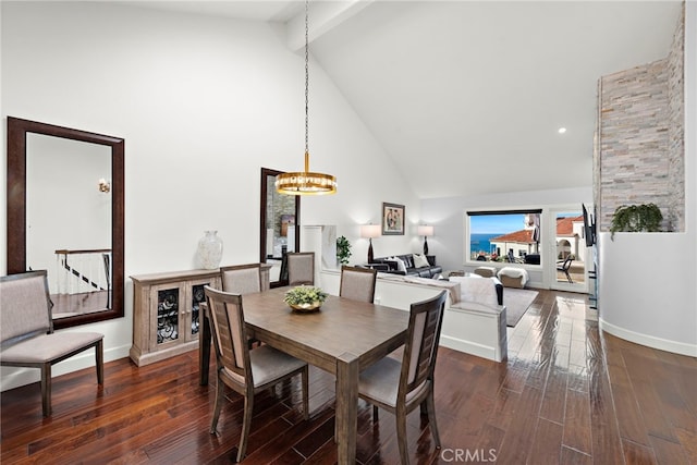 dining space with beamed ceiling, high vaulted ceiling, an inviting chandelier, and dark hardwood / wood-style flooring