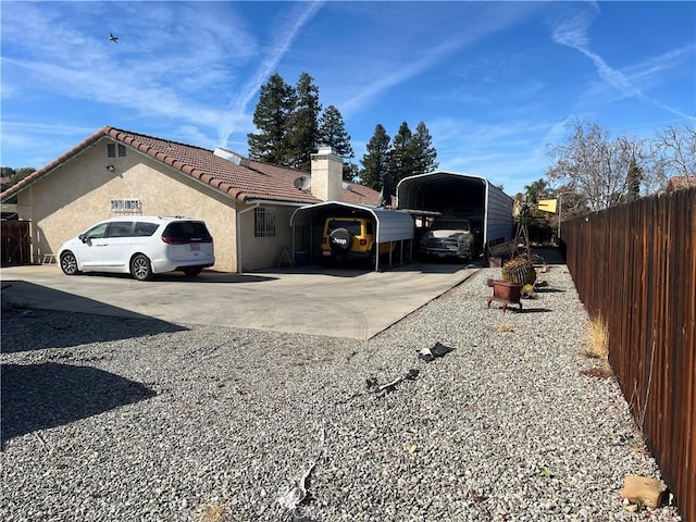 view of side of property with a carport