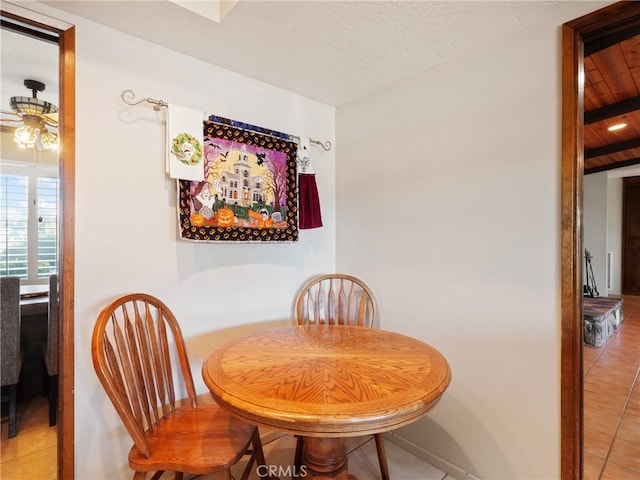 tiled dining area with ceiling fan