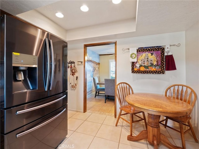 kitchen featuring stainless steel fridge with ice dispenser and light tile patterned floors