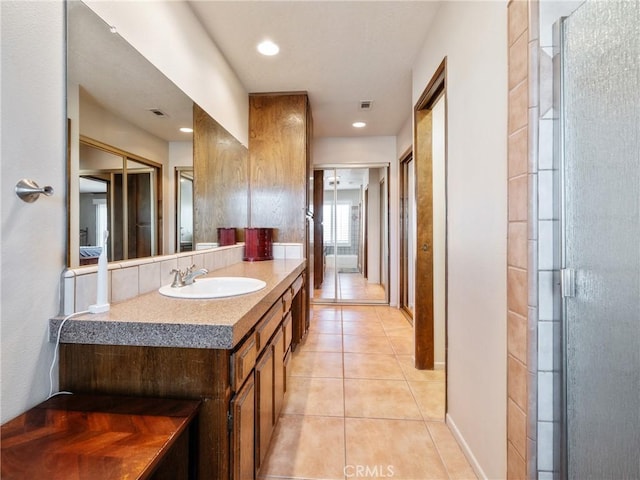 bathroom with vanity, a shower with door, and tile patterned floors