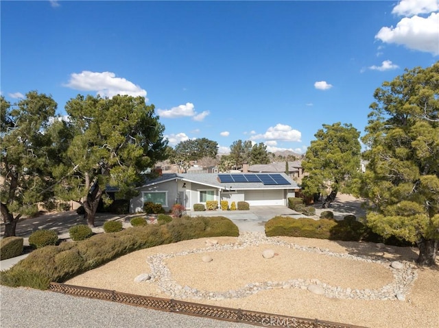 view of front of house featuring a garage and solar panels