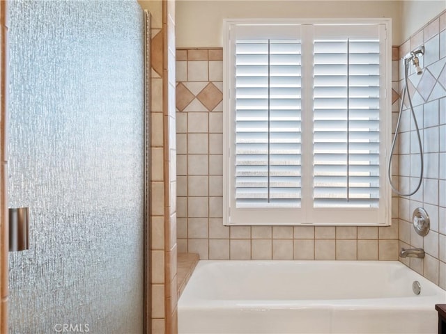 bathroom featuring independent shower and bath