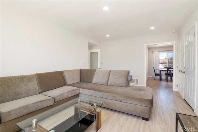 living room featuring recessed lighting, visible vents, baseboards, and wood finished floors