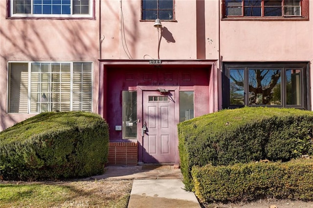 property entrance featuring stucco siding