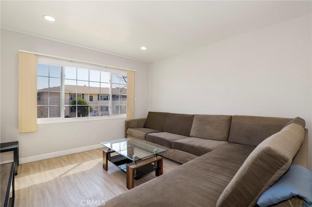 living room featuring recessed lighting, baseboards, and wood finished floors