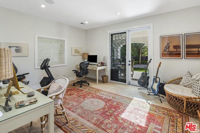 office area with light hardwood / wood-style floors