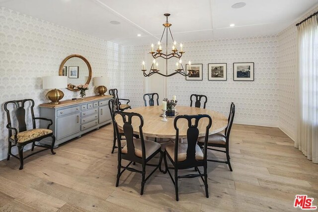 dining space featuring an inviting chandelier and light wood-type flooring