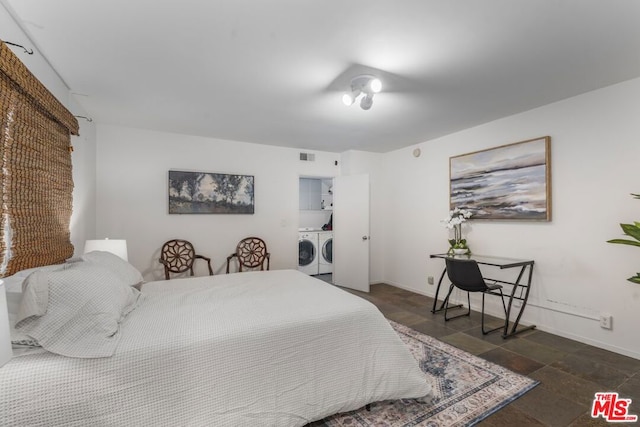 bedroom featuring independent washer and dryer