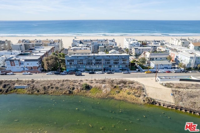 drone / aerial view with a water view and a view of the beach