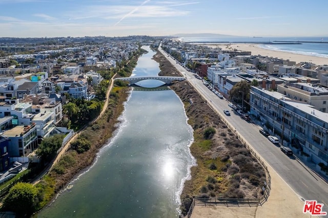 aerial view featuring a water view and a beach view