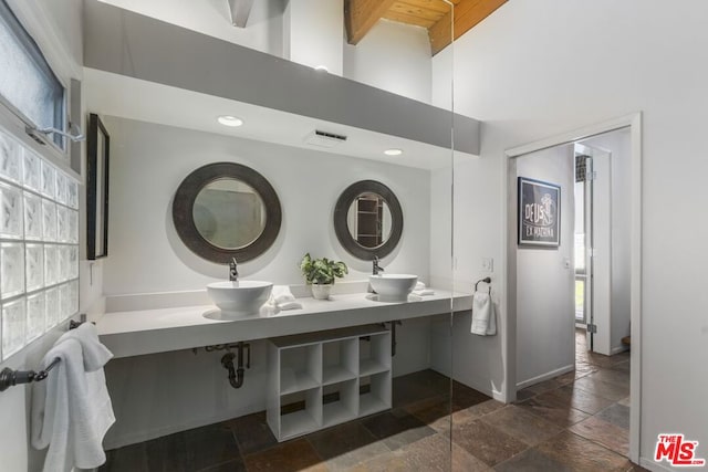 bathroom with sink and a high ceiling