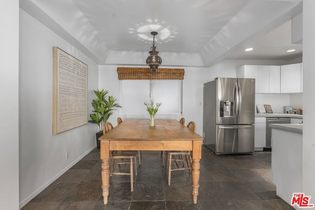 dining area featuring a tray ceiling