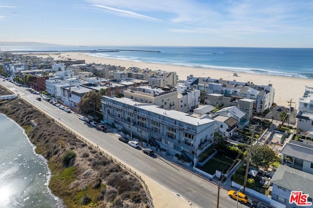 drone / aerial view with a water view and a view of the beach