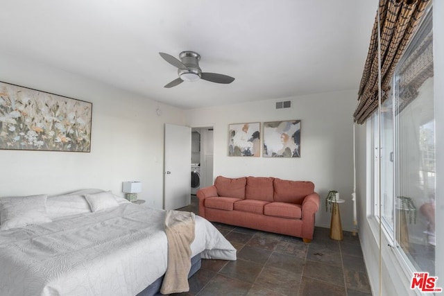 bedroom with washer / clothes dryer and ceiling fan