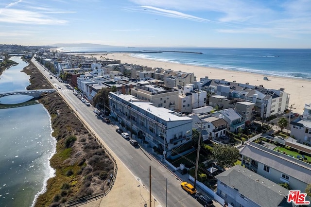 birds eye view of property featuring a water view and a beach view